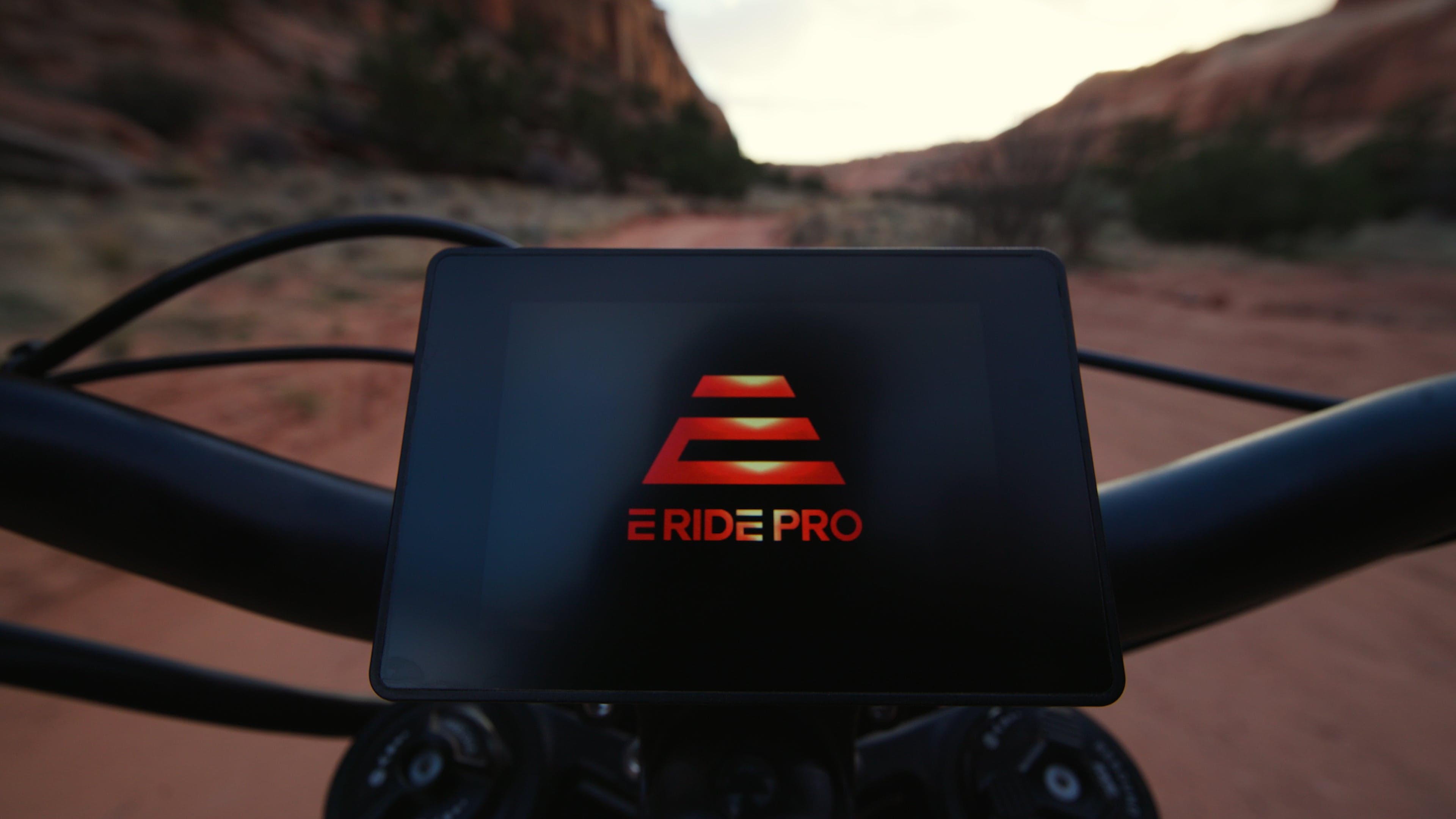 Rider silhouette at mountain summit with electric dirt bike